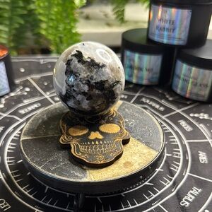 Polished Black and White Crystal Sphere on Decorative Skull Stand